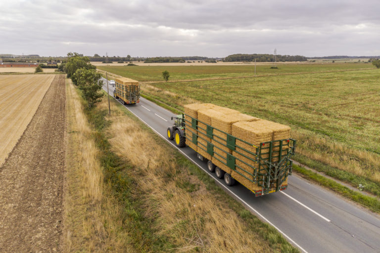a pair of bailey bale trailers on the road