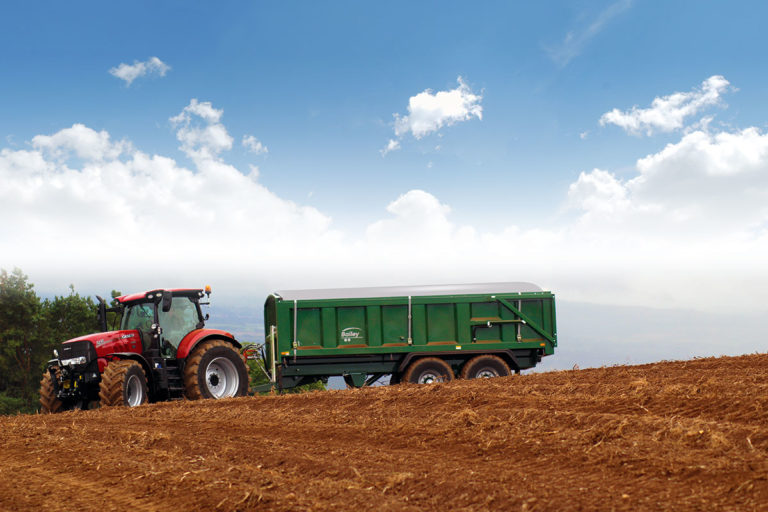 Sheeting system covering crop loaded trailer