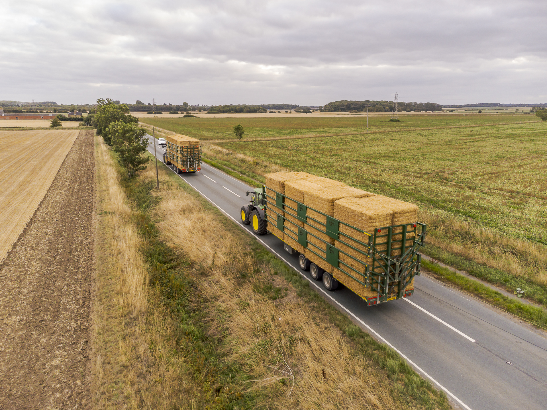 a pair of bailey bale trailers transporting a full load of safely clamped bales
